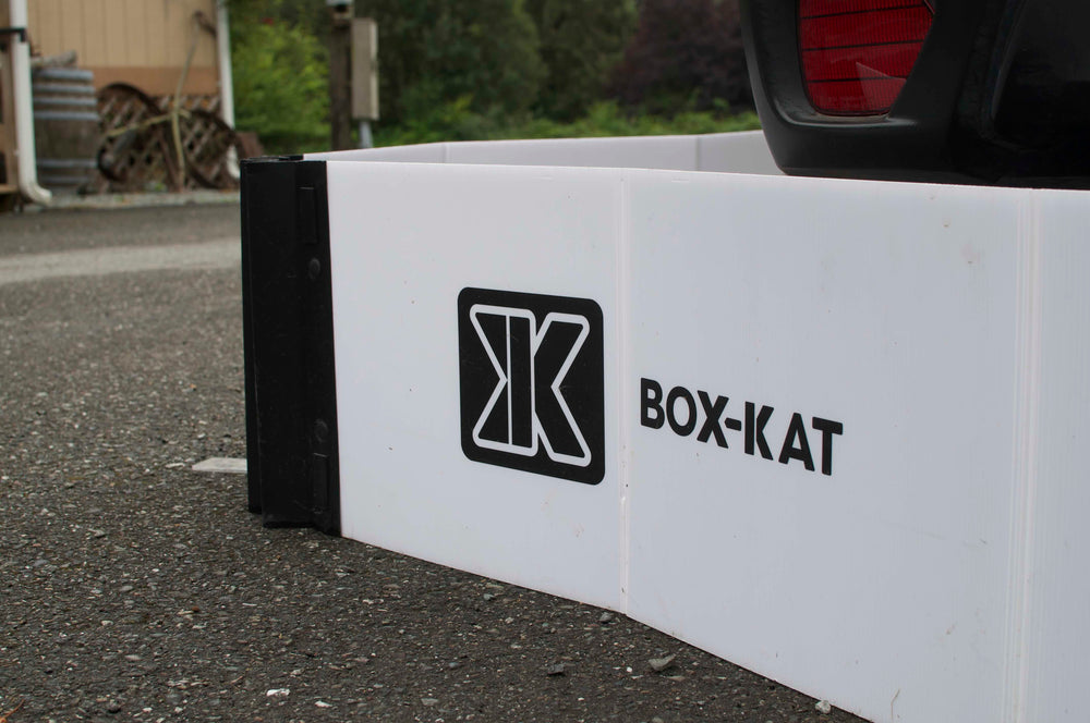 Box-Kat owner standing beside a car parked inside a Box-Kat barrier