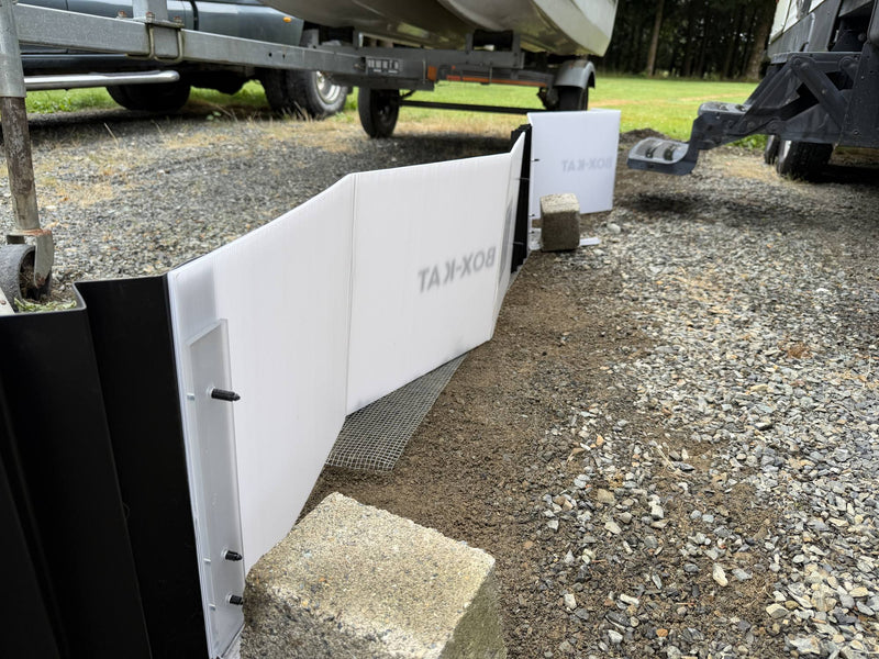 Paver blocks set on the support braces of a Box-Kat barrier on gravel