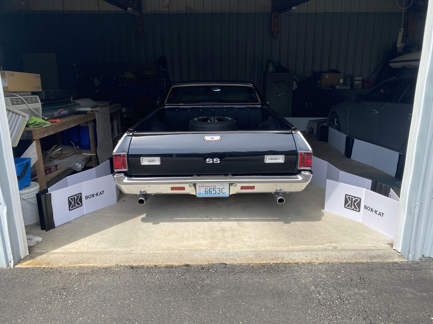 Vintage el camino parked inside a Box-Kat mouse barrier inside a garage