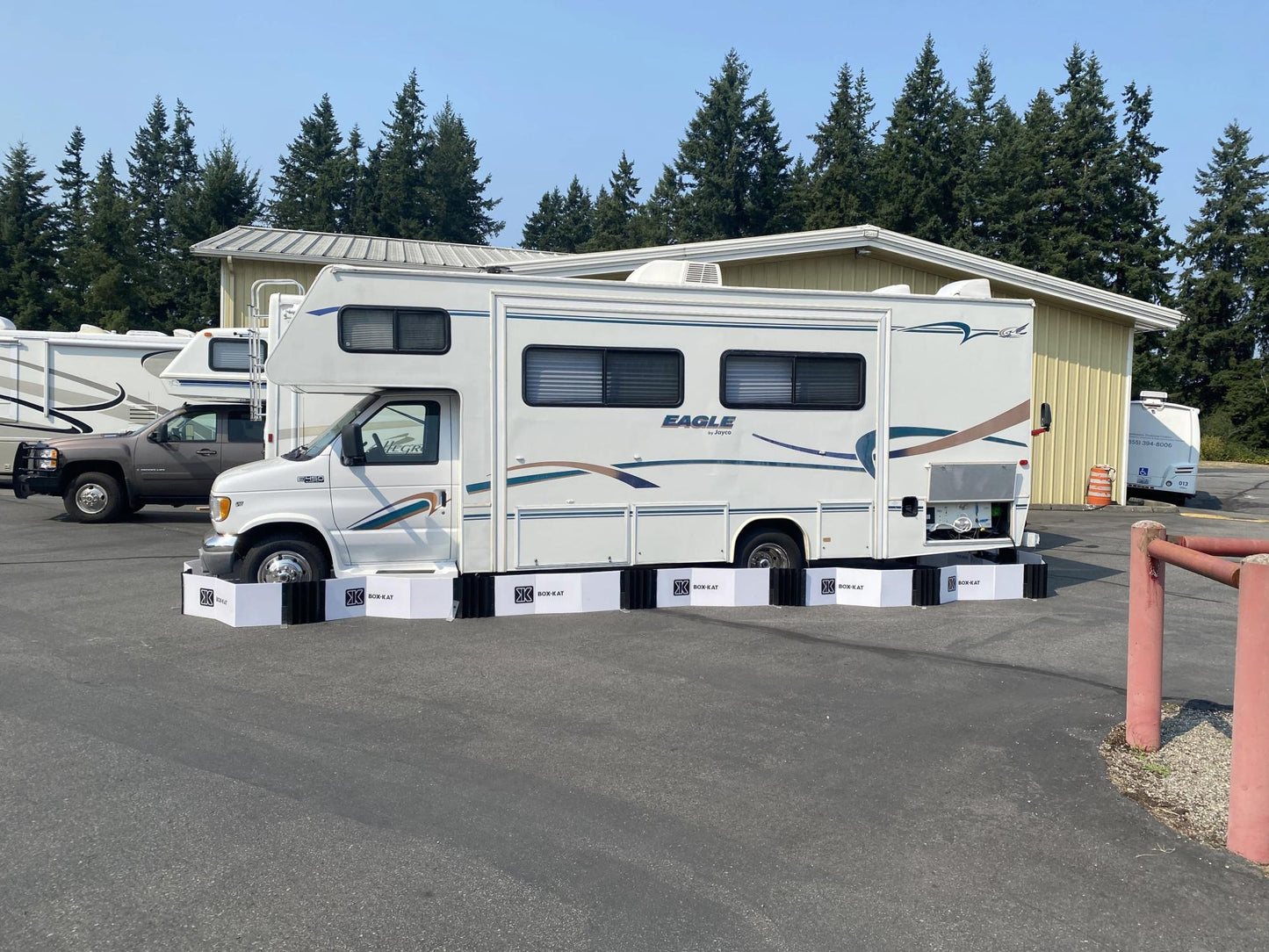 White RV parked outdoors inside a box-kat mouse barrier