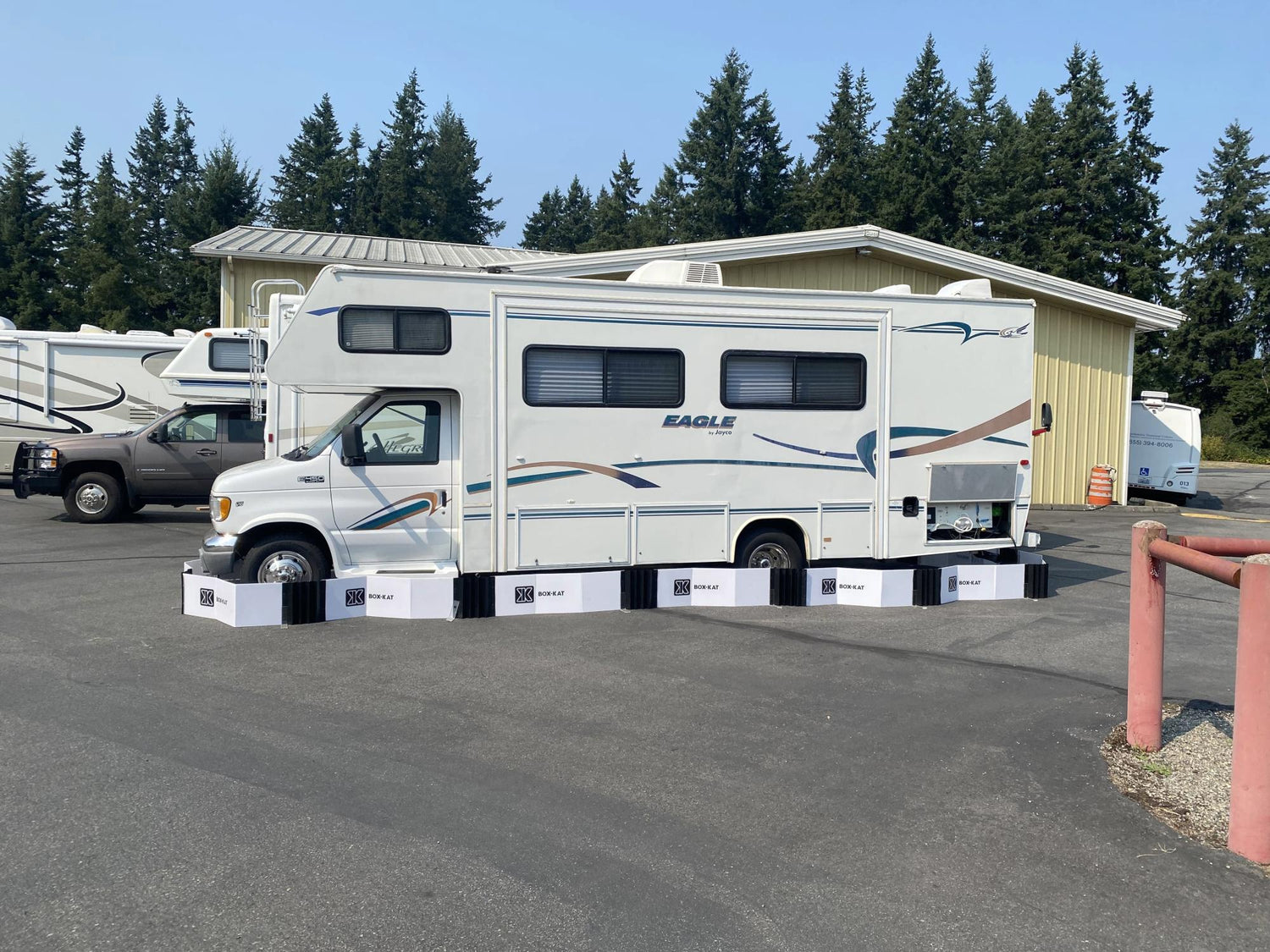 White RV parked outdoors inside a box-kat mouse barrier