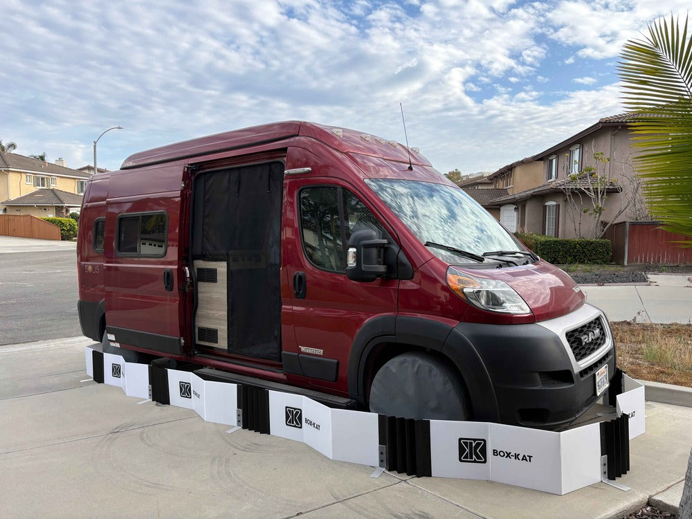 Box-Kat mouse barrier surrounding red van parked in a driveway