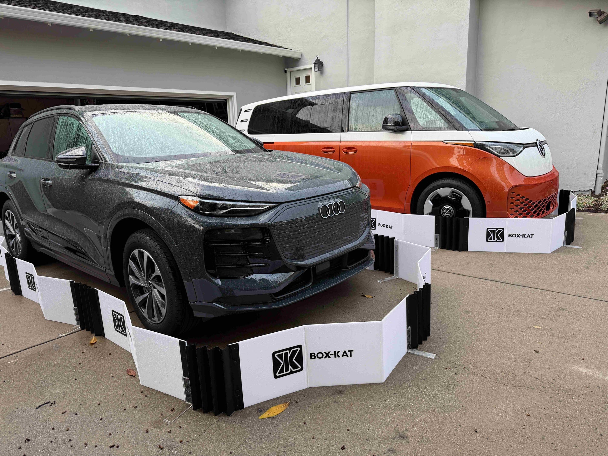 Two cars inside of Box-Kat mouse barriers in driveway
