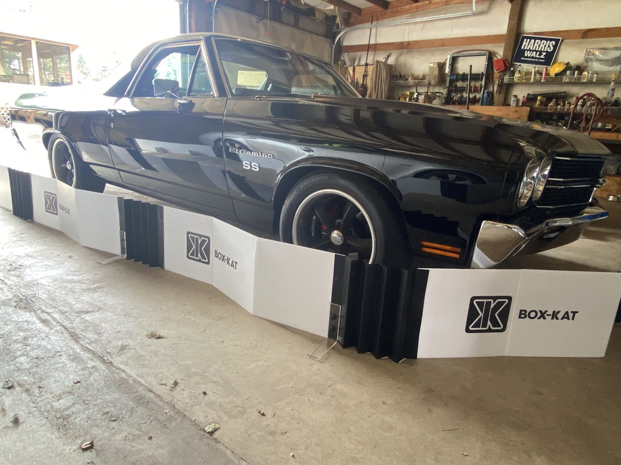 Box-kat mouse barrier protecting a black classic car in a garage