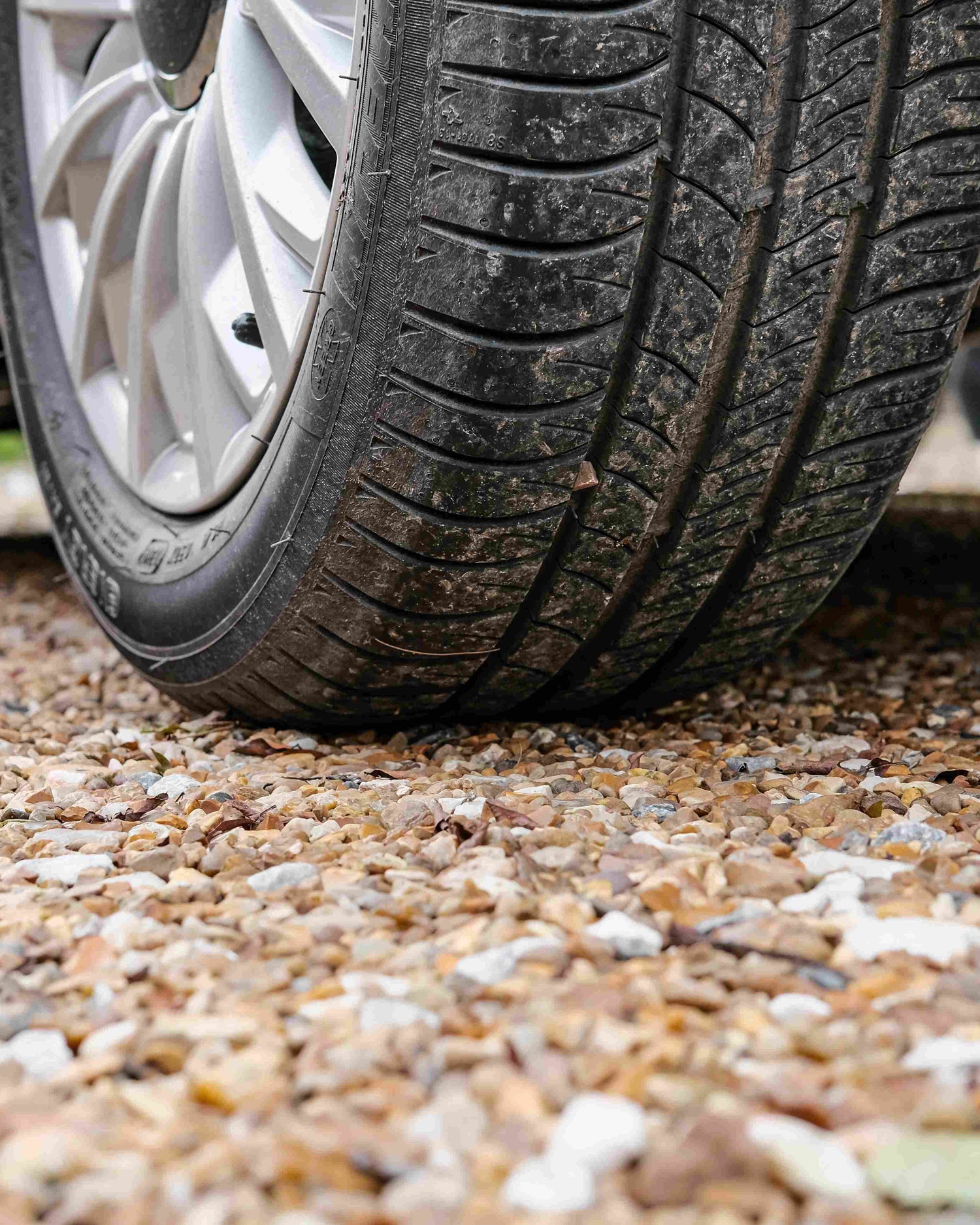 Car tire on a gravel surface