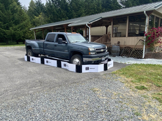 Box-Kat mouse barrier around pickup truck on gravel lot
